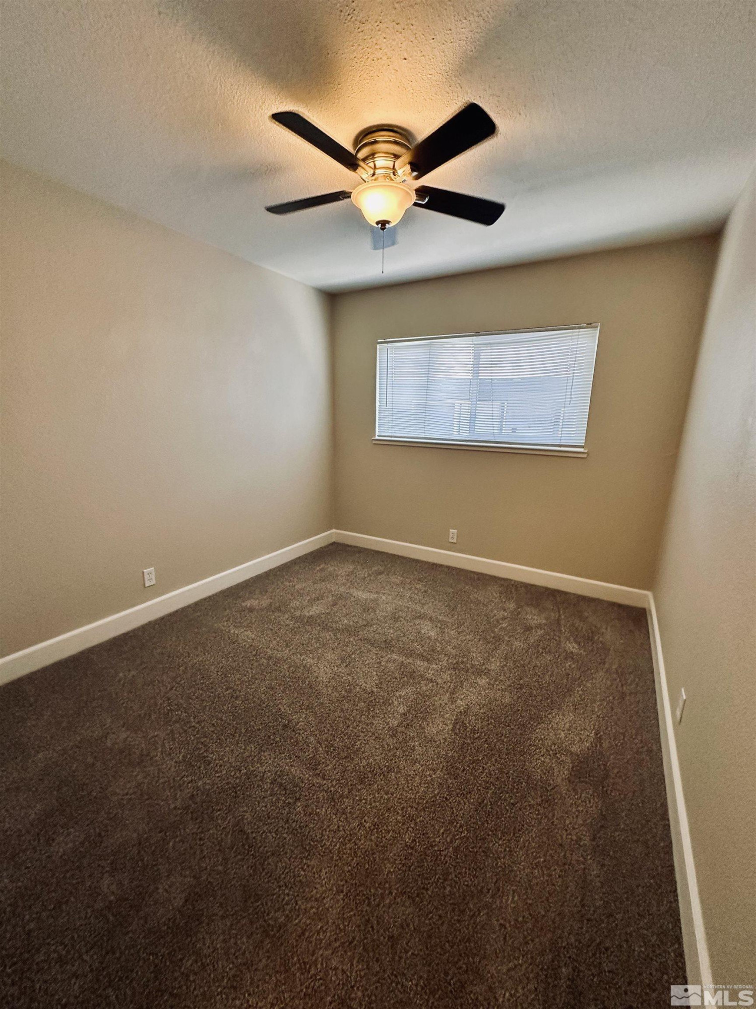 1945 Gridley Avenue Reno, NV 89503 - Photo 14 of 27 an empty room with a ceiling fan and a window