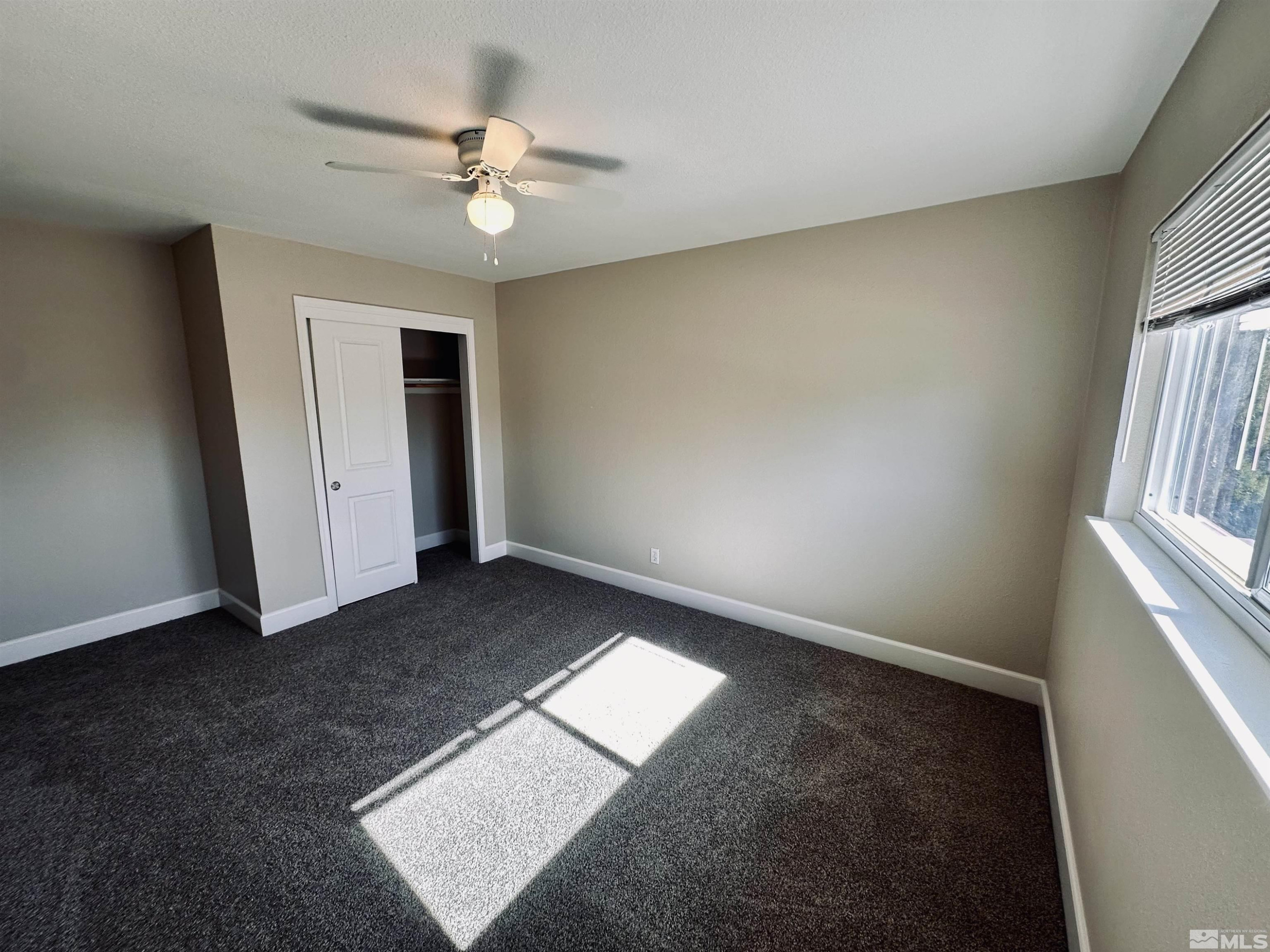 1945 Gridley Avenue Reno, NV 89503 - Photo 17 of 27 an empty room with a ceiling fan and window