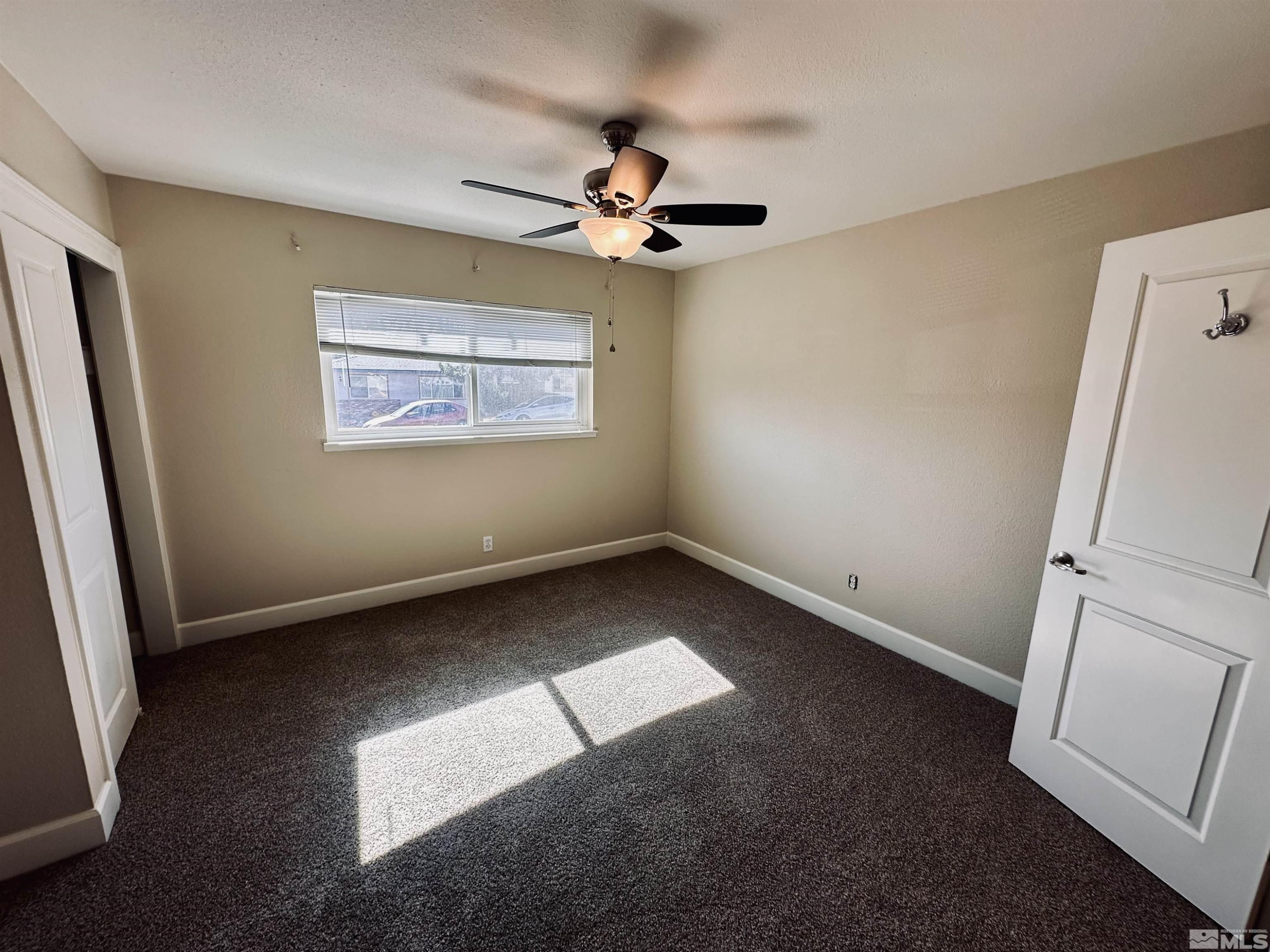 1945 Gridley Avenue Reno, NV 89503 - Photo 18 of 27 an empty room with windows and fan