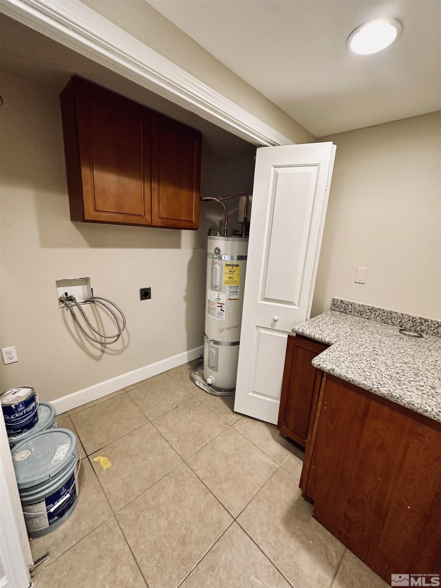1945 Gridley Avenue Reno, NV 89503 - Photo 4 of 27 a bathroom with a granite countertop sink and a washing machine