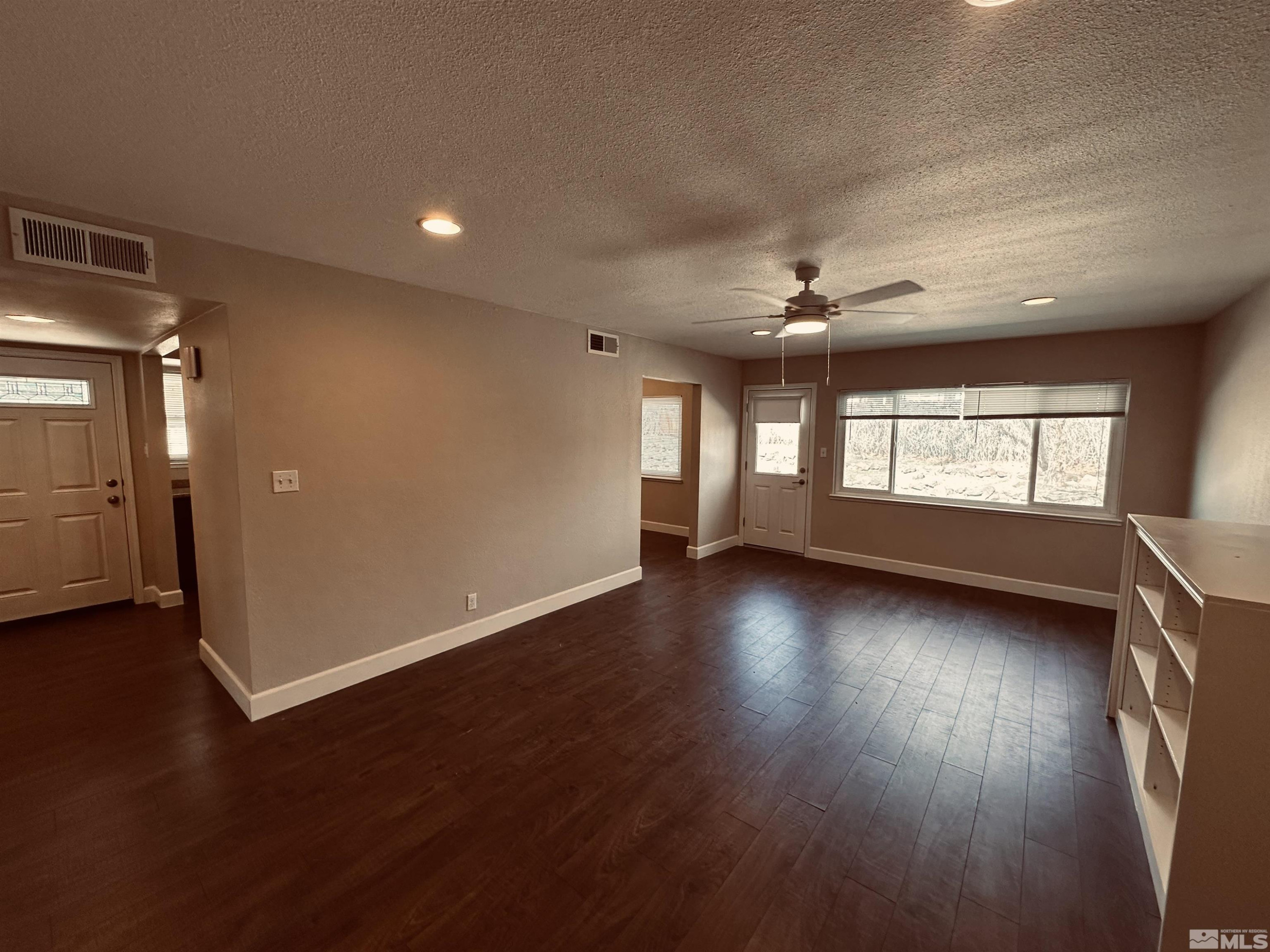1945 Gridley Avenue Reno, NV 89503 - Photo 10 of 27 an empty room with wooden floor and windows