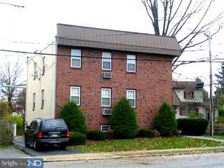 206 Rockingham Road Bryn Mawr, PA 19010 - Photo 2 of 6 a car parked in front of a brick house