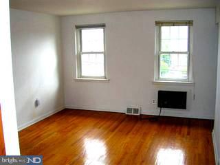 206 Rockingham Road Bryn Mawr, PA 19010 - Photo 4 of 6 an empty room with wooden floor and windows