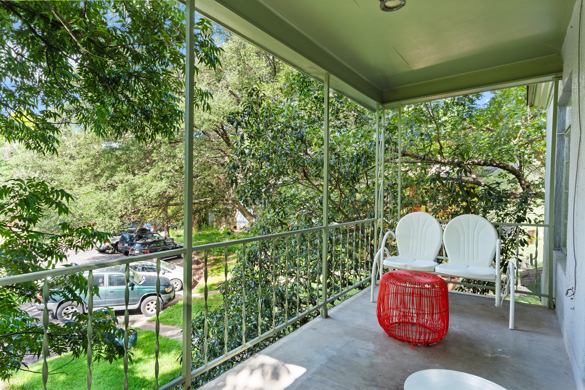 1302 Kirkwood Road, Unit B Austin, TX 78722 - Photo 21 of 21 A breezy, tree-shaded porch offers a serene spot for relaxation and neighborhood views.