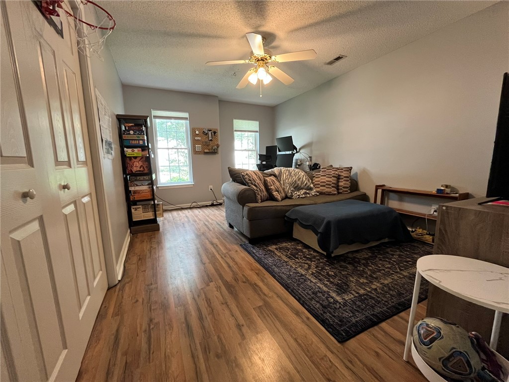 116 Arbors Court Central, SC 29630 - Photo 24 of 27 A versatile living area features warm wood flooring and abundant natural light from two windows.