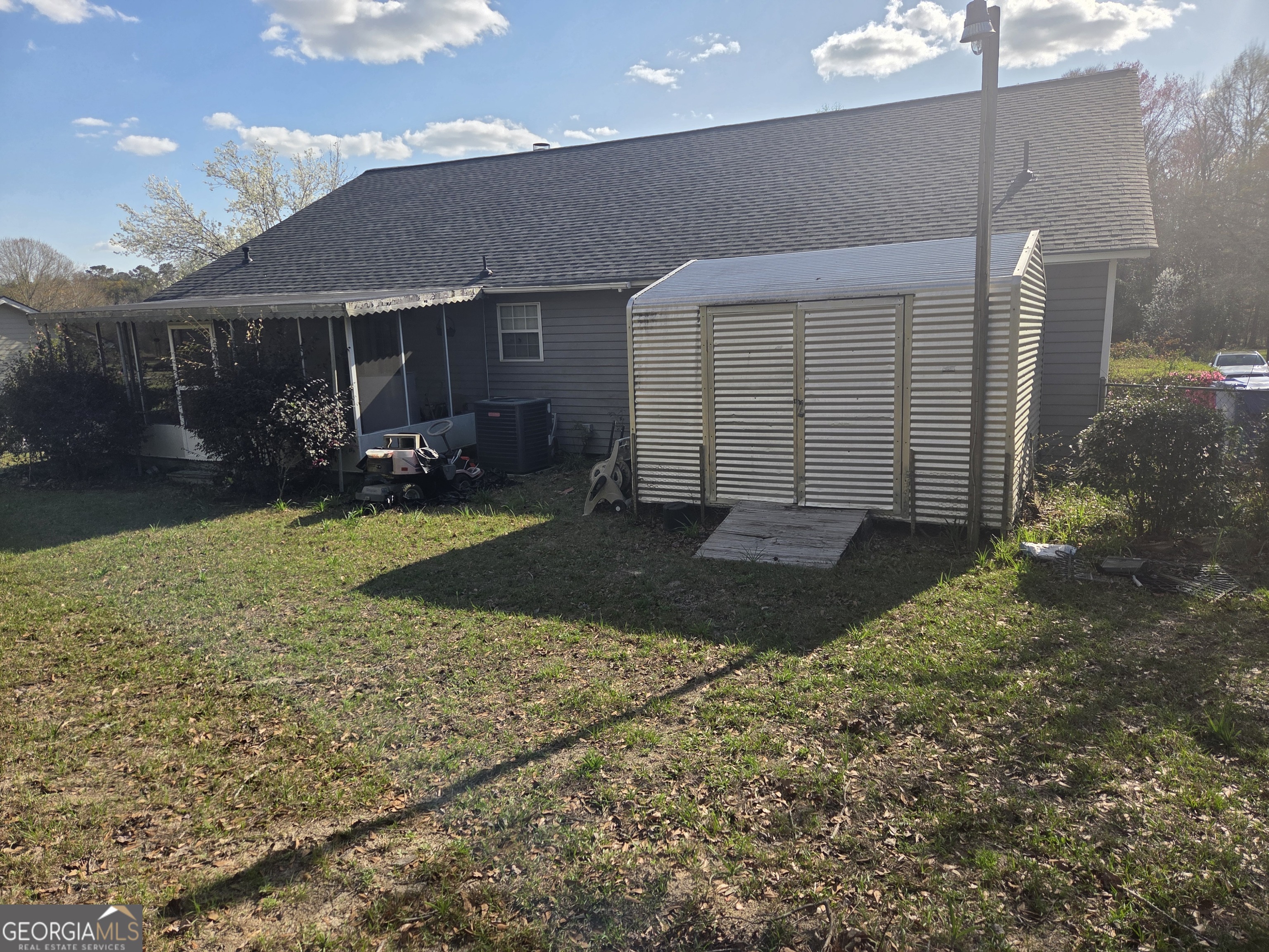 213 Lancelot Lane Dublin, GA 31021 - Photo 12 of 12 a front view of a house with a yard and outdoor seating