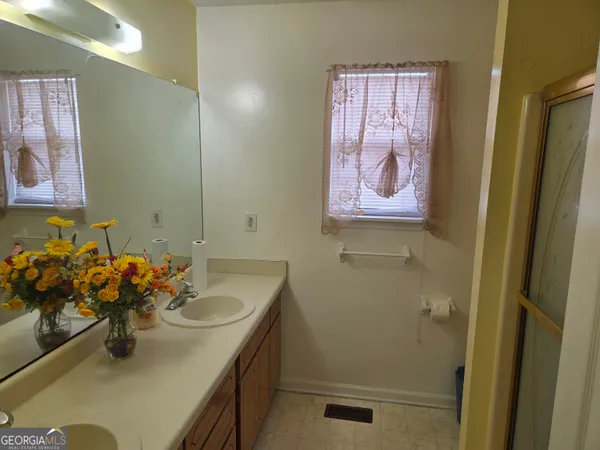 a bathroom with a sink mirror and vanity