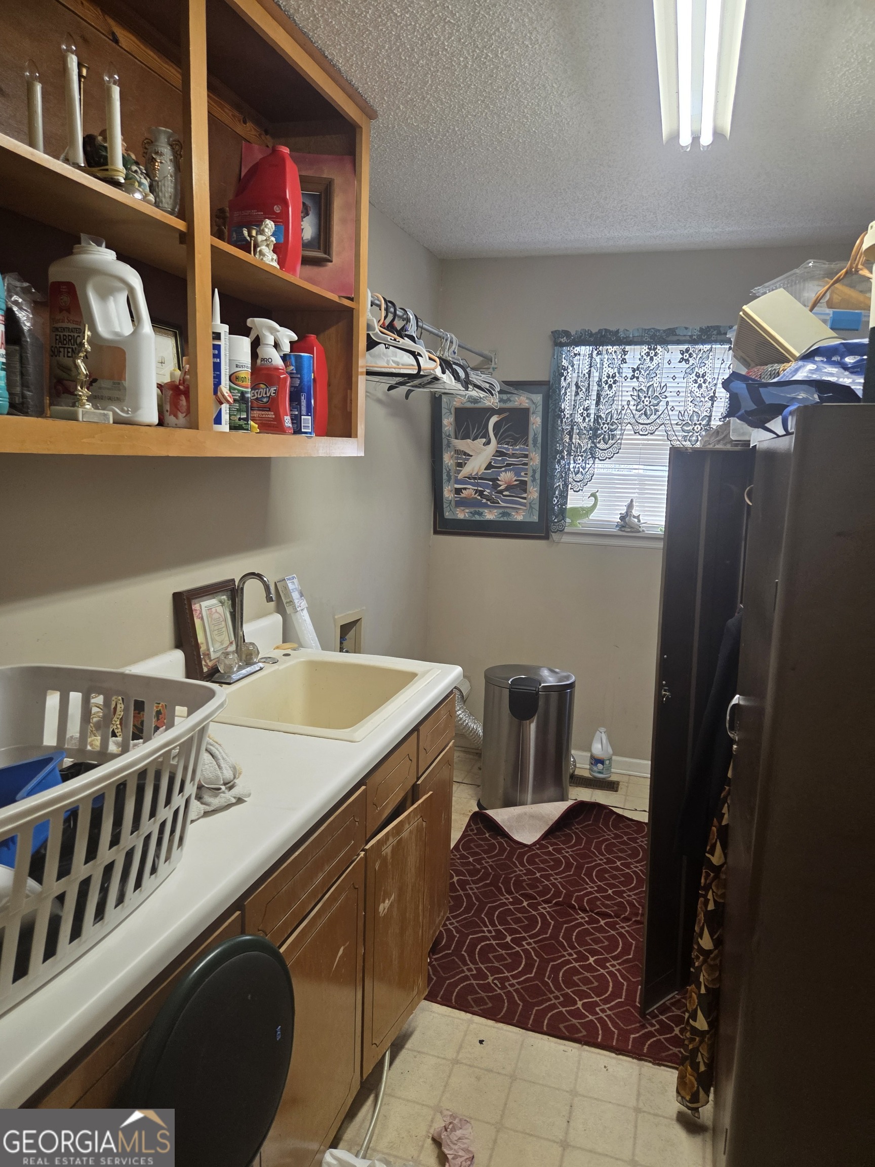 213 Lancelot Lane Dublin, GA 31021 - Photo 9 of 12 a kitchen with a refrigerator and a stove