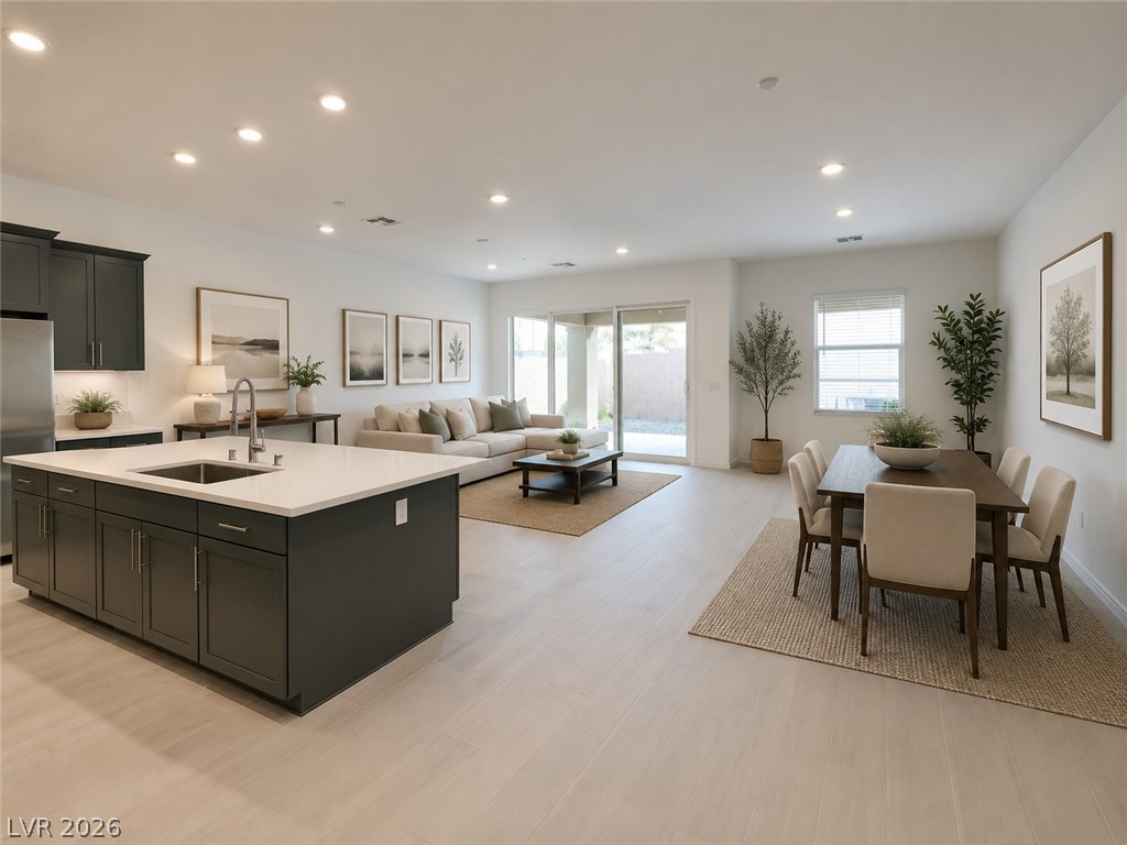 37 Charlotte Ridge Place Henderson, NV 89011 - Photo 44 of 44 An open floorplan seamlessly connects the kitchen to the sun-filled living and dining areas, ideal for modern living. *Virtually Staged*