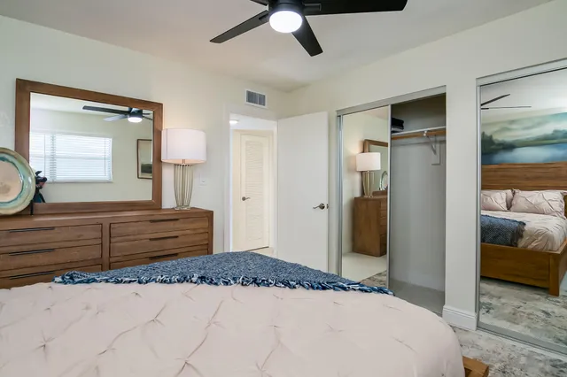 a bedroom with a bed and a dresser