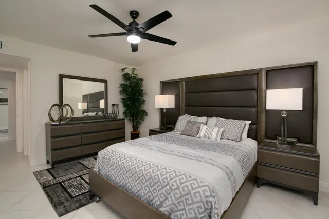 a bedroom with a bed and a chandelier