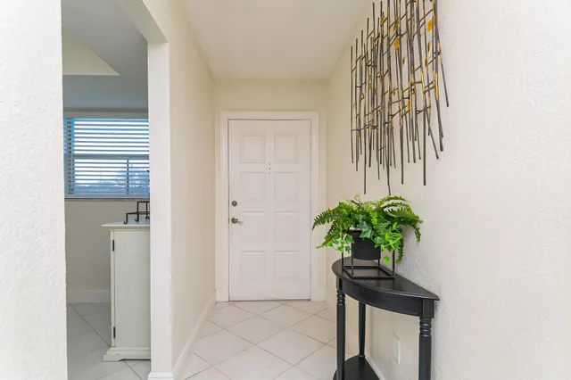 a vase of flowers sitting on a floor