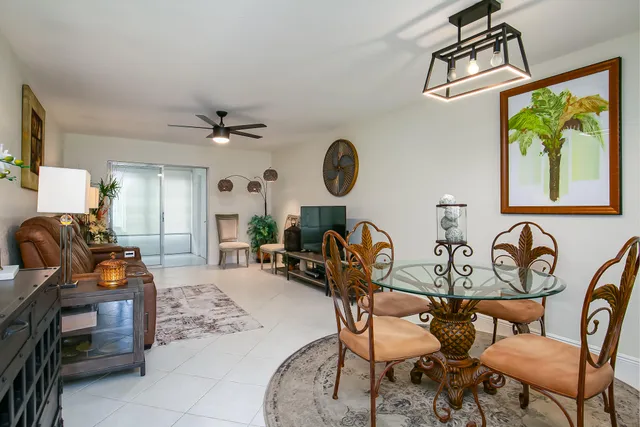 a view of a livingroom and a dining room with furniture window and outside view