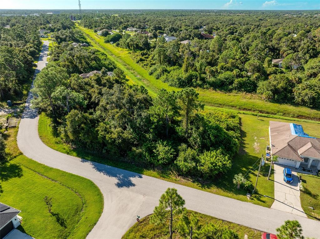 6465 Ohio Rd Port North Port, FL 34291 - Photo 12 of 34 an aerial view of a house with a yard and lake view