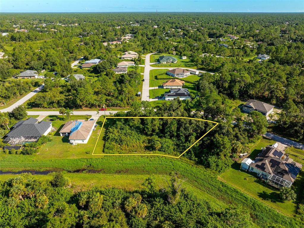 6465 Ohio Rd Port North Port, FL 34291 - Photo 15 of 34 an aerial view of residential houses with outdoor space and trees
