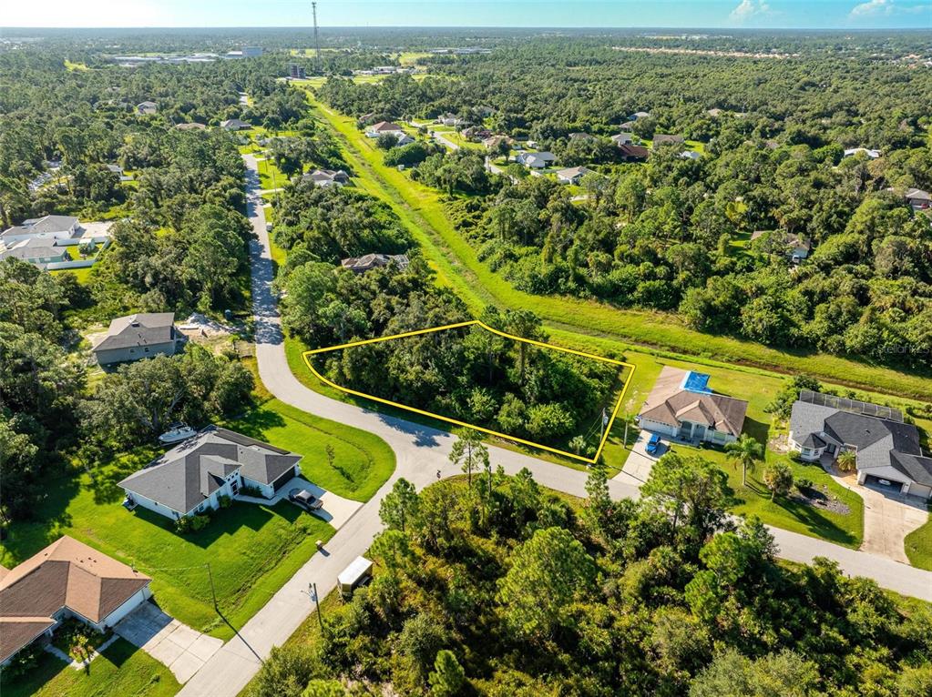 6465 Ohio Rd Port North Port, FL 34291 - Photo 5 of 34 an aerial view of a residential houses with a yard and lake view