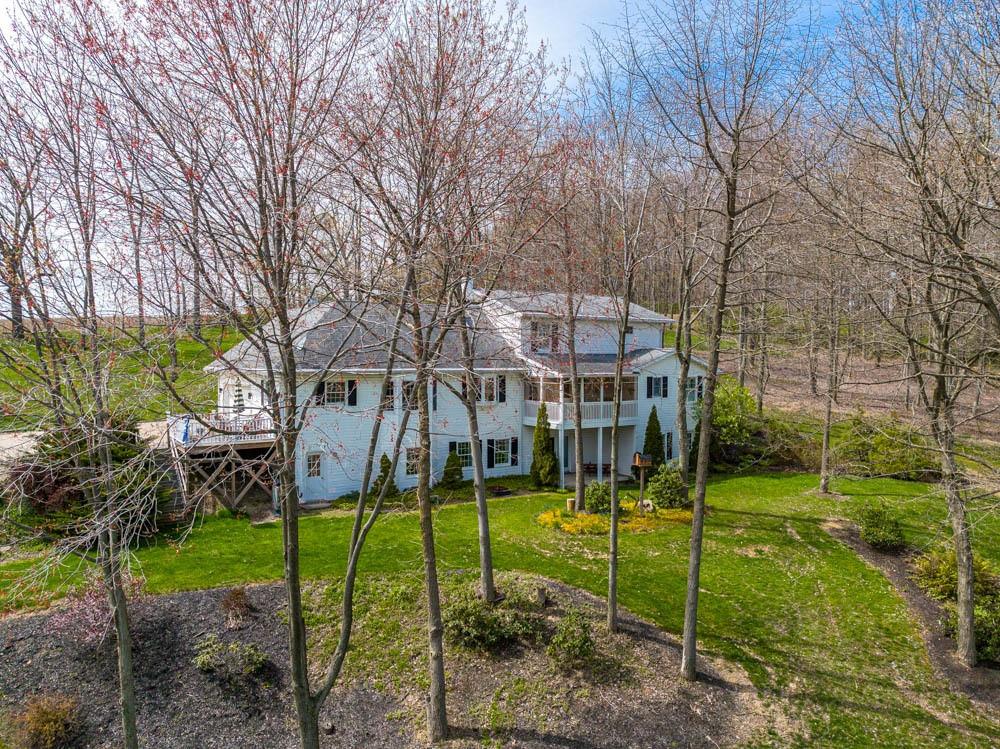 225 Levis Road Portersville, PA 16051 - Photo 23 of 24 a view of a house with a backyard and a tree
