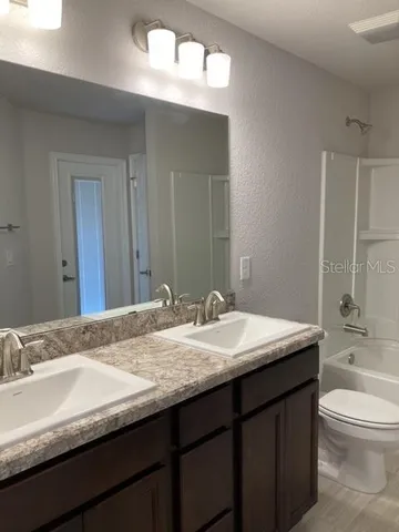 a kitchen with stainless steel appliances kitchen island granite countertop a stove a sink and a microwave