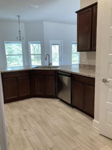 a bathroom with a granite countertop sink a toilet and shower