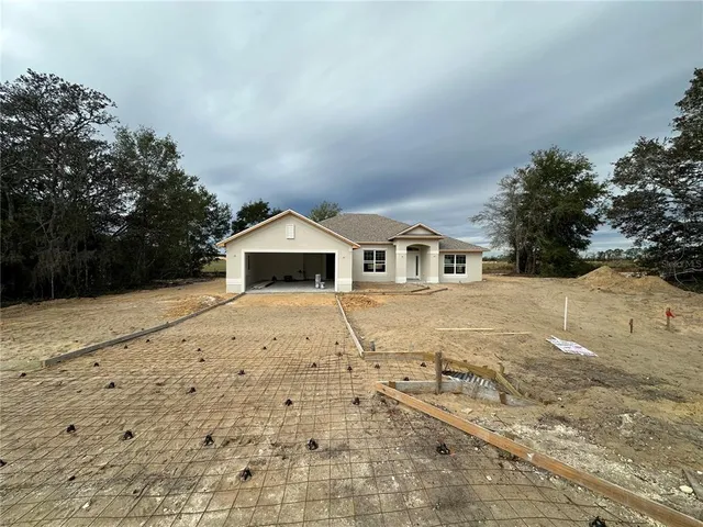 a yellow and white house with a outdoor space