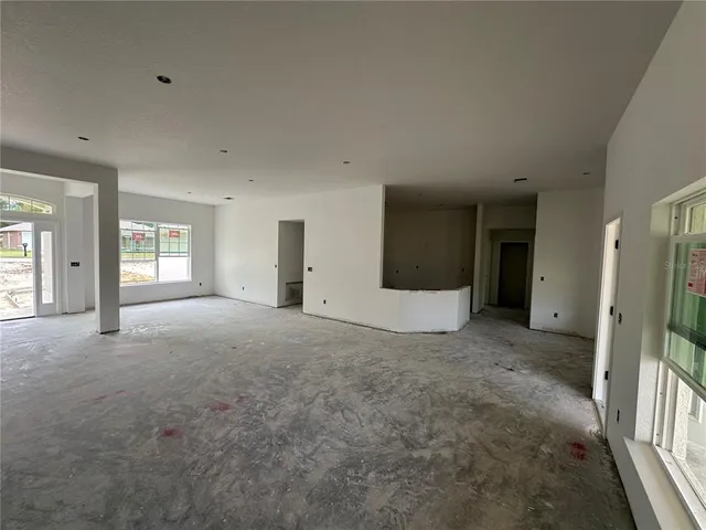 a view of a big room with windows and entryway