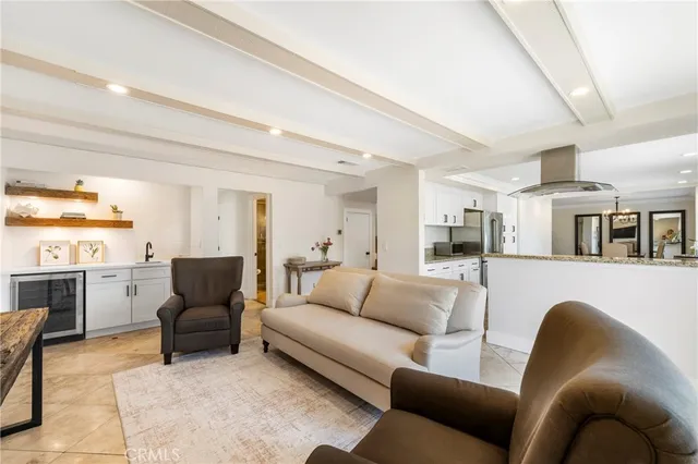a living room with furniture and a kitchen view