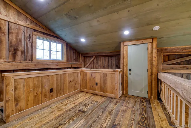 a kitchen with cabinets and wooden floor