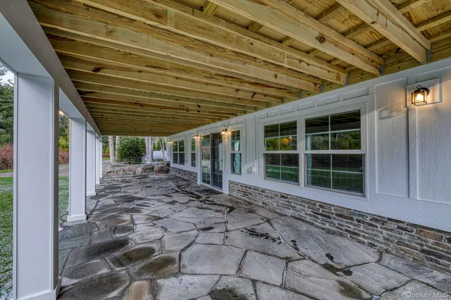 a view of a porch with wooden walls