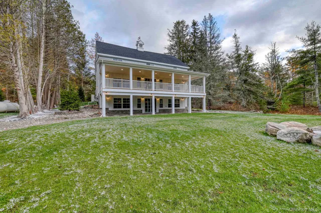 a view of a house with yard and sitting area