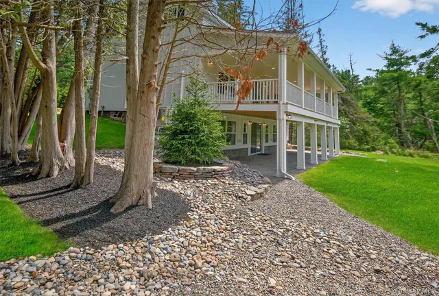a view of a big house with a yard and plants