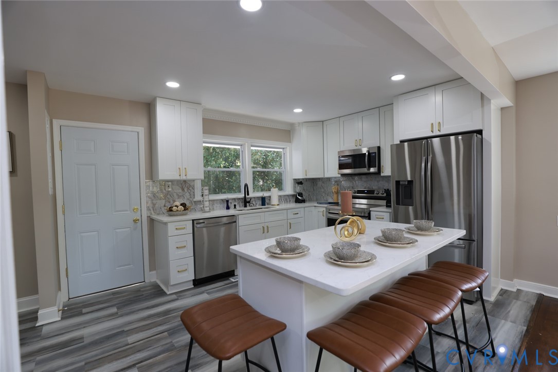 3007 Dunwick Road Richmond, VA 23230 - Photo 24 of 49 Kitchen featuring white cabinetry, stainless steel