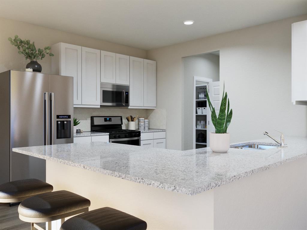 1500 Romans Road Ennis, TX 75119 - Photo 27 of 38 a kitchen with granite countertop a refrigerator a stove and a sink