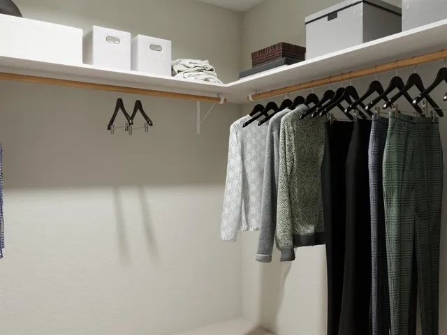 a bedroom with a large bed and a couch