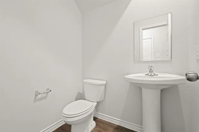 a bathroom with a sink toilet and a mirror