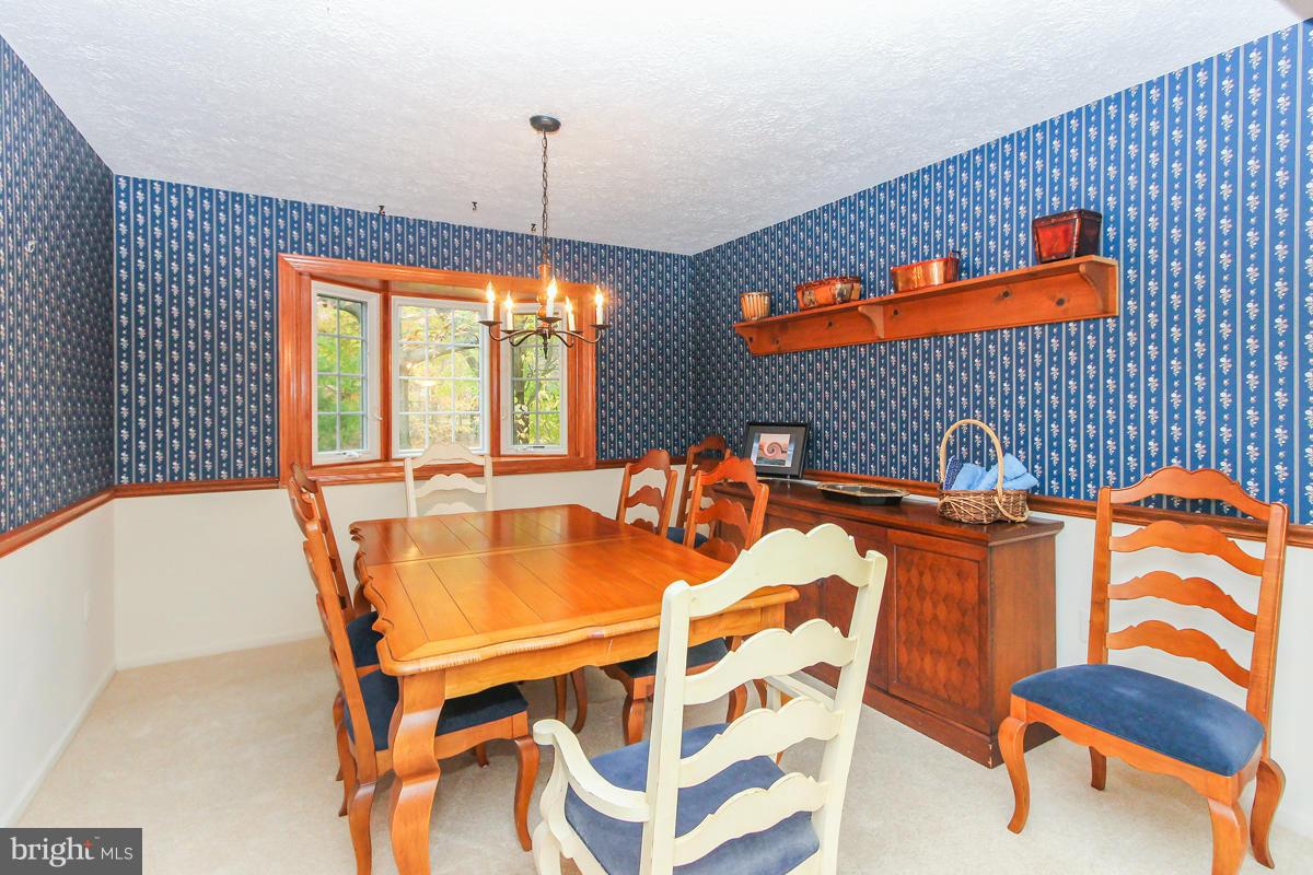 1861 Post Oak Trail Reston, VA 20191 - Photo 11 of 30 a view of a dining room with furniture and chandelier