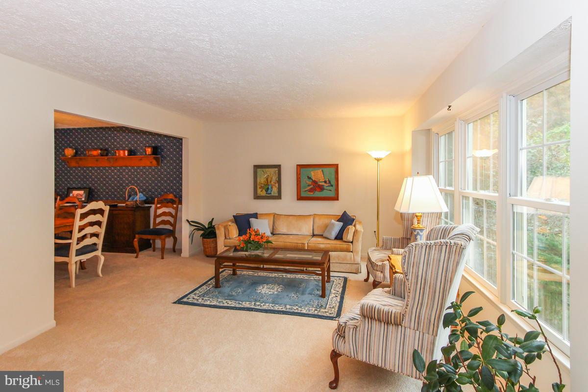 1861 Post Oak Trail Reston, VA 20191 - Photo 12 of 30 a living room with furniture a flat screen tv and a large window