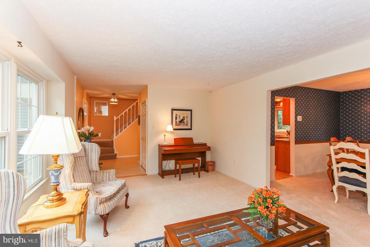 1861 Post Oak Trail Reston, VA 20191 - Photo 15 of 30 a living room with furniture and a table