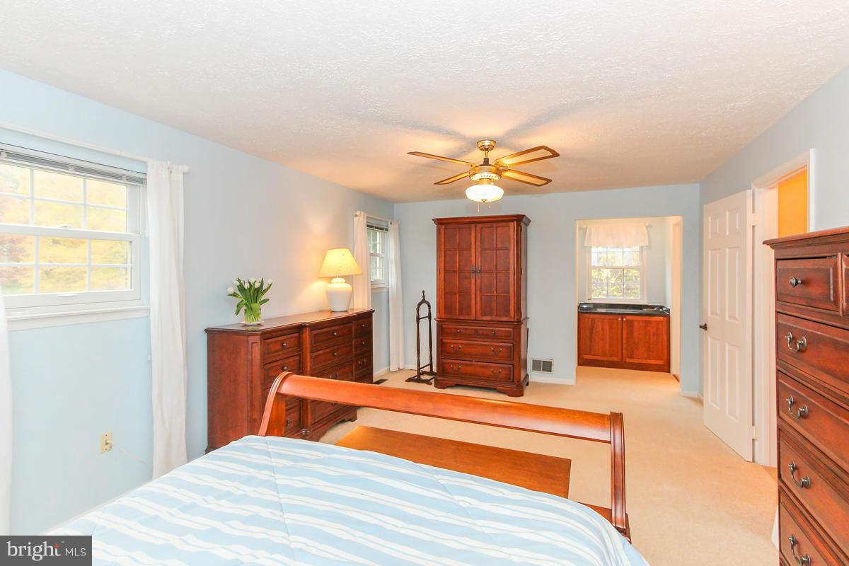 1861 Post Oak Trail Reston, VA 20191 - Photo 18 of 30 a bedroom with a bed and closet with mirror