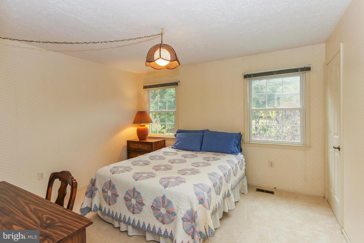 1861 Post Oak Trail Reston, VA 20191 - Photo 21 of 30 a bedroom with a bed and a window