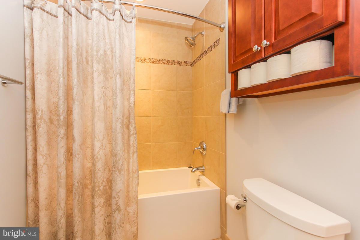 1861 Post Oak Trail Reston, VA 20191 - Photo 25 of 30 a bathroom with a shower a toilet and a sink