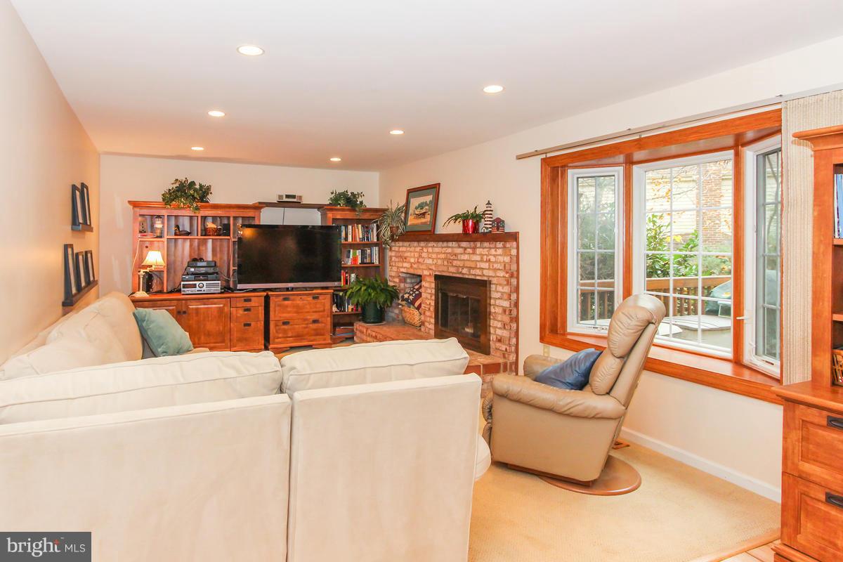 1861 Post Oak Trail Reston, VA 20191 - Photo 7 of 30 a living room with furniture a flat screen tv and a fireplace