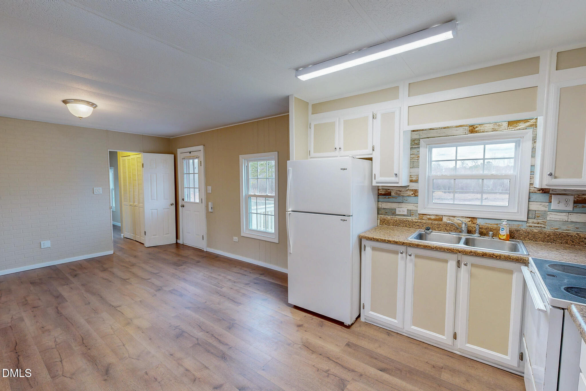 410 Berea Road Rougemont, NC 27572 - Photo 3 of 18 a kitchen with a refrigerator a sink and dishwasher with wooden floor