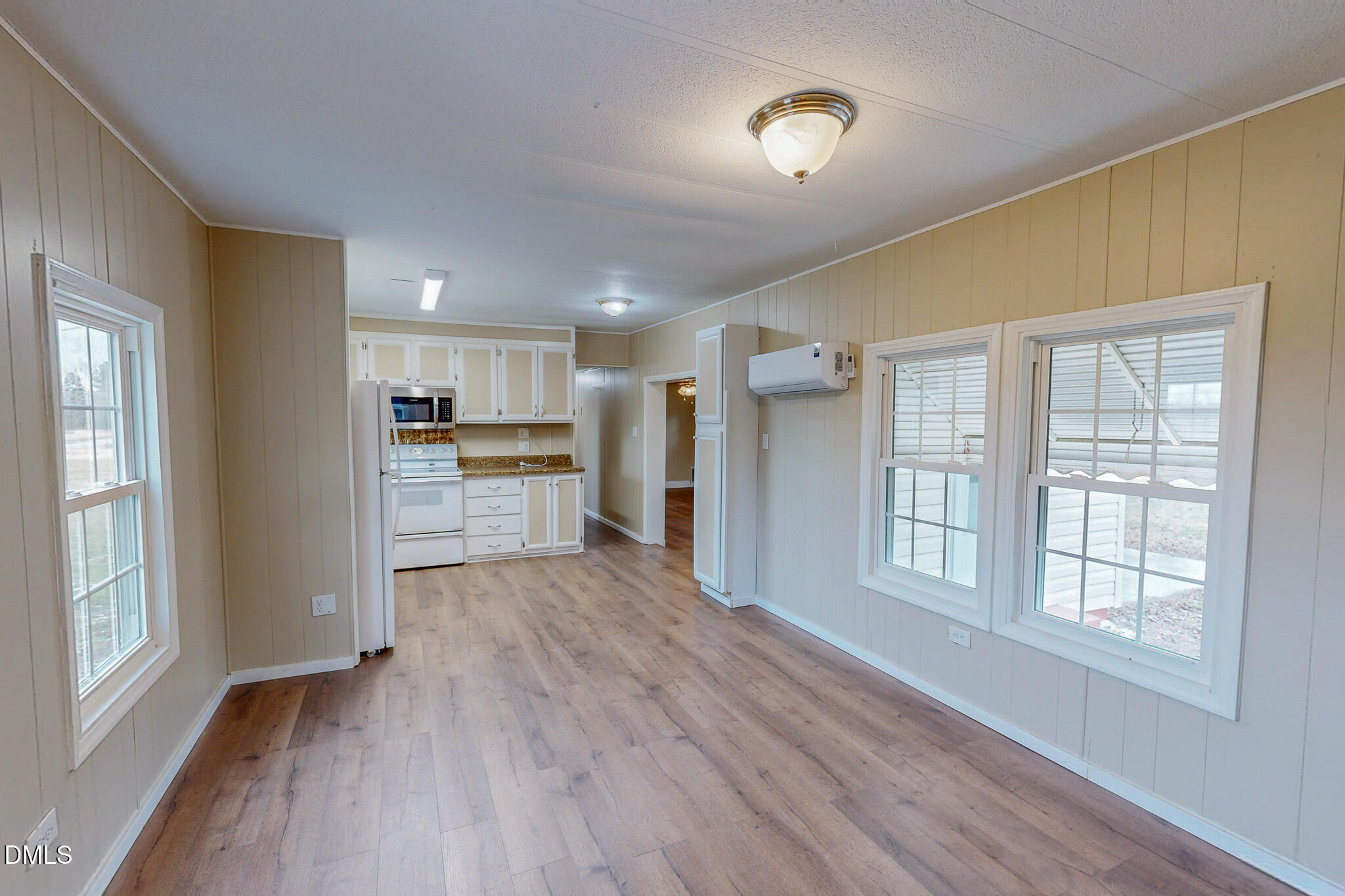 410 Berea Road Rougemont, NC 27572 - Photo 4 of 18 a view of an empty room with a window and wooden floor