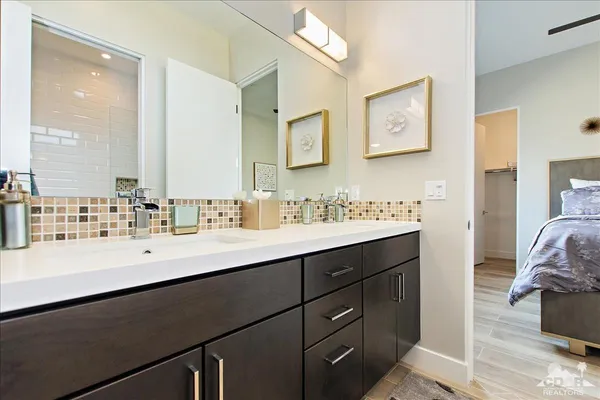 a bathroom with a sink double vanity and a mirror