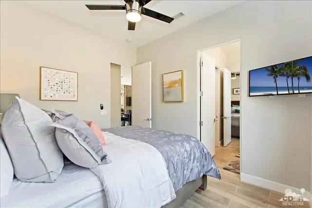 a bedroom with a bed and a chandelier