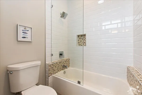 a bathroom with a toilet and a bathtub