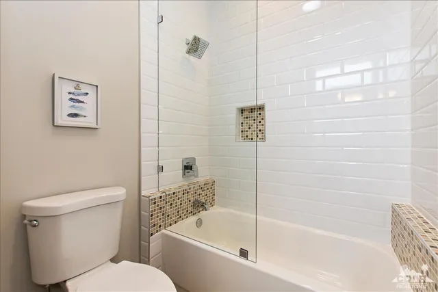 a bathroom with a toilet and a bathtub