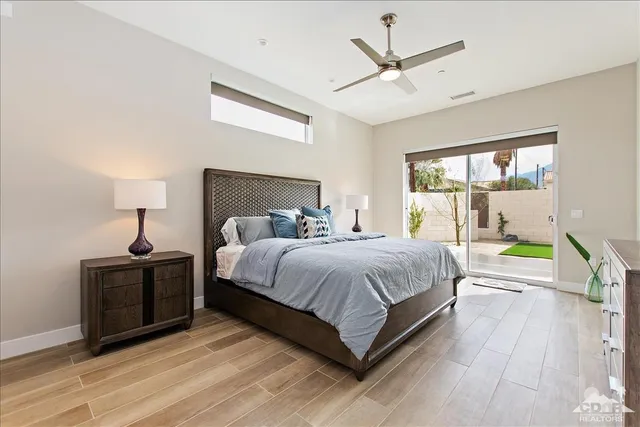 a bedroom with a bed a window and a chandelier