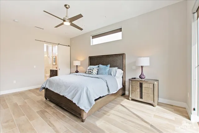 a bedroom with a bed and a lamp