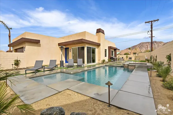 a view of a swimming pool with a lounge chairs